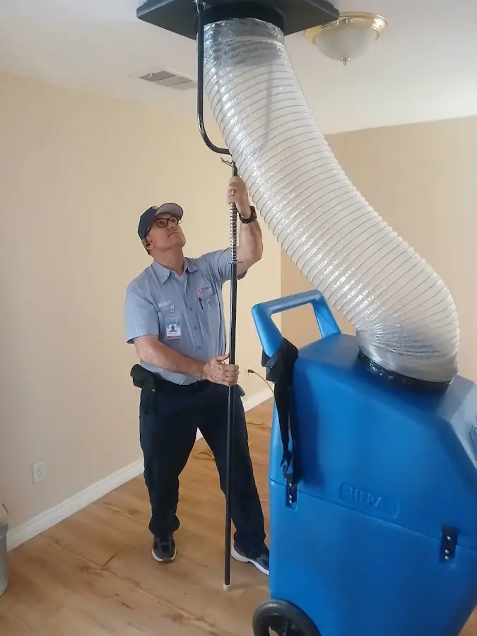 Furnace Tune-Up technician using HEPA equipment in Creve Coeur